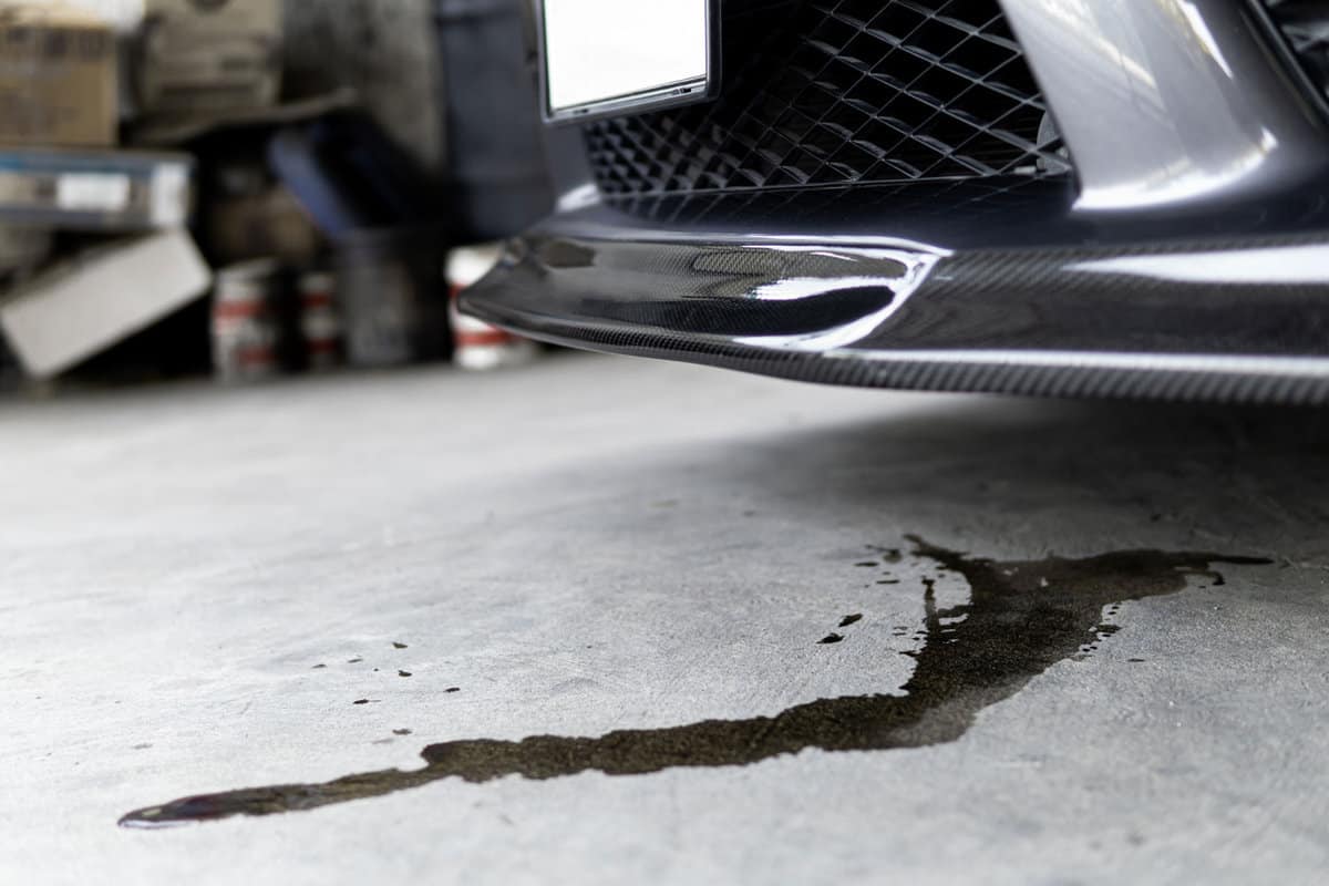 Engine oil stains of car Leak under the car when the car is park In the garage service floor photo concept for check and maintenance 