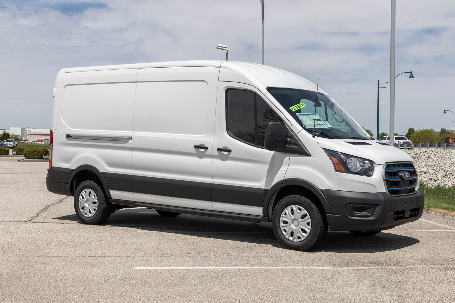 Ford E-Transit Cargo Van at a dealership. The Ford E-Transit has an electric motor providing 266hp with a maximum payload of 3,880 pounds.