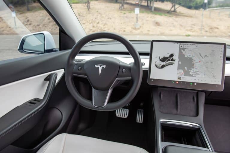 Interior details of steering wheel and touch screen display in white Tesla Model Y with white leather interior, How To Use Valet Mode On Tesla Model Y
