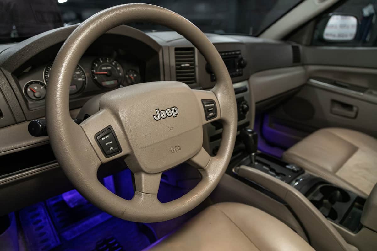 Jeep, Beige luxury car Interior - dashboard, player, steering wheel with logo and buttons, speedometer