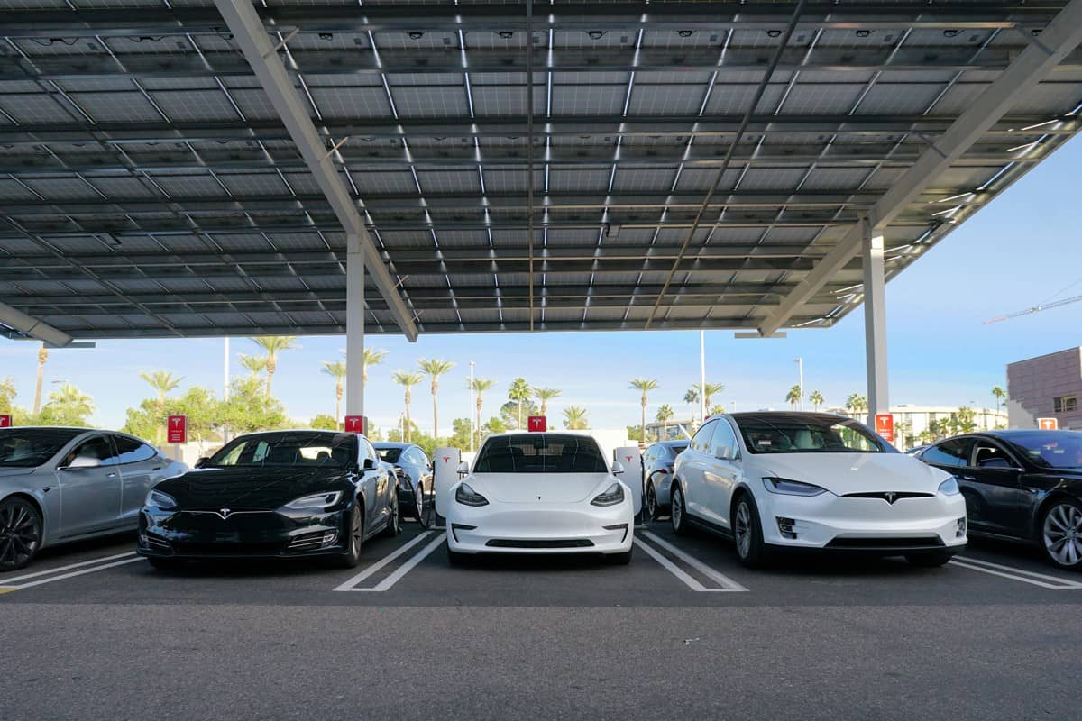  Tesla cars charging at an urban supercharger 