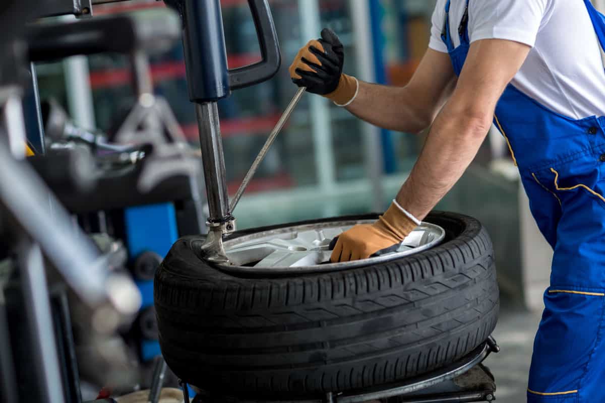 Worker changing the tire for a brand new one