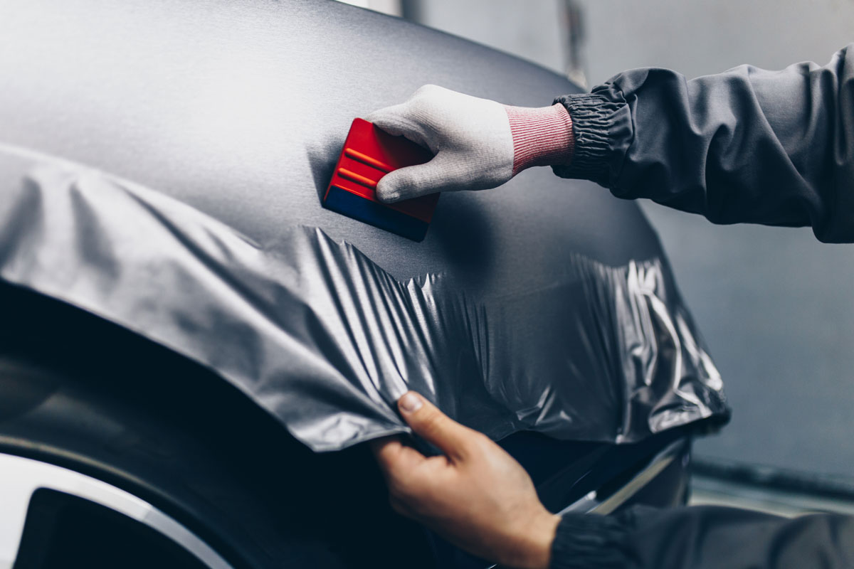 car wrapping specialist putting matte vinyl foil