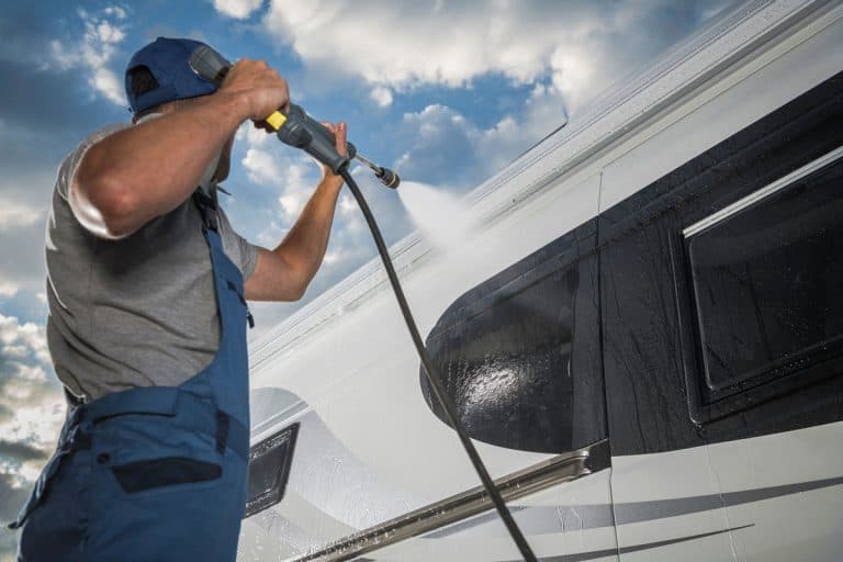 caucasian men pressure washing his modern, How To Clean RV Caulking And Sealant
