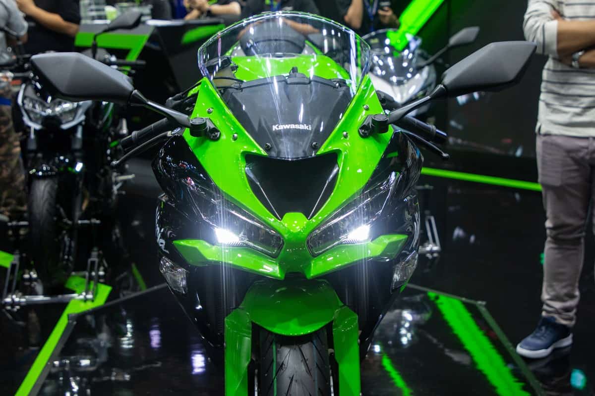  close up front view of Kawasaki Ninja green and black color motorbike presented in motor expo