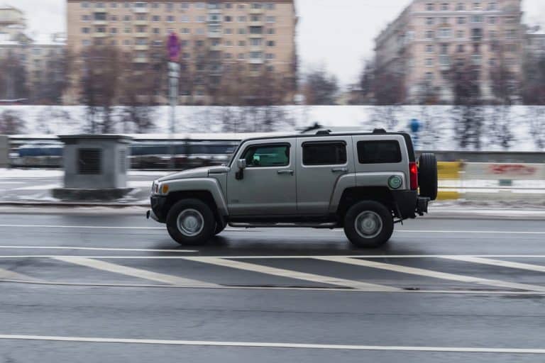 fast moving Hummer H3 SUV rides on a winter city road. A car on wet slippery road in motion. Overspeed in city concept., How To Set Cruise Control On Hummer H3 [Step-By-Step Guide]