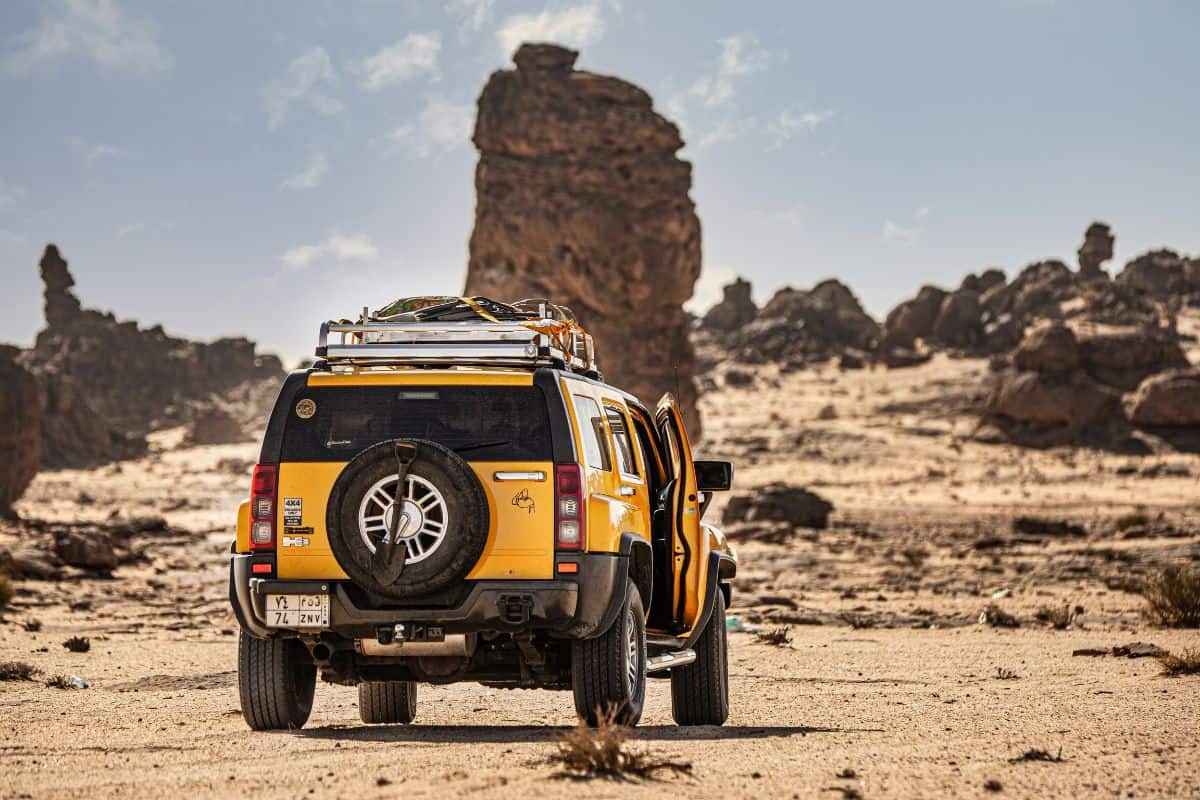 4X4 Hummer in the desert Gharameel Towers in the North West region of Saudi Arabia.