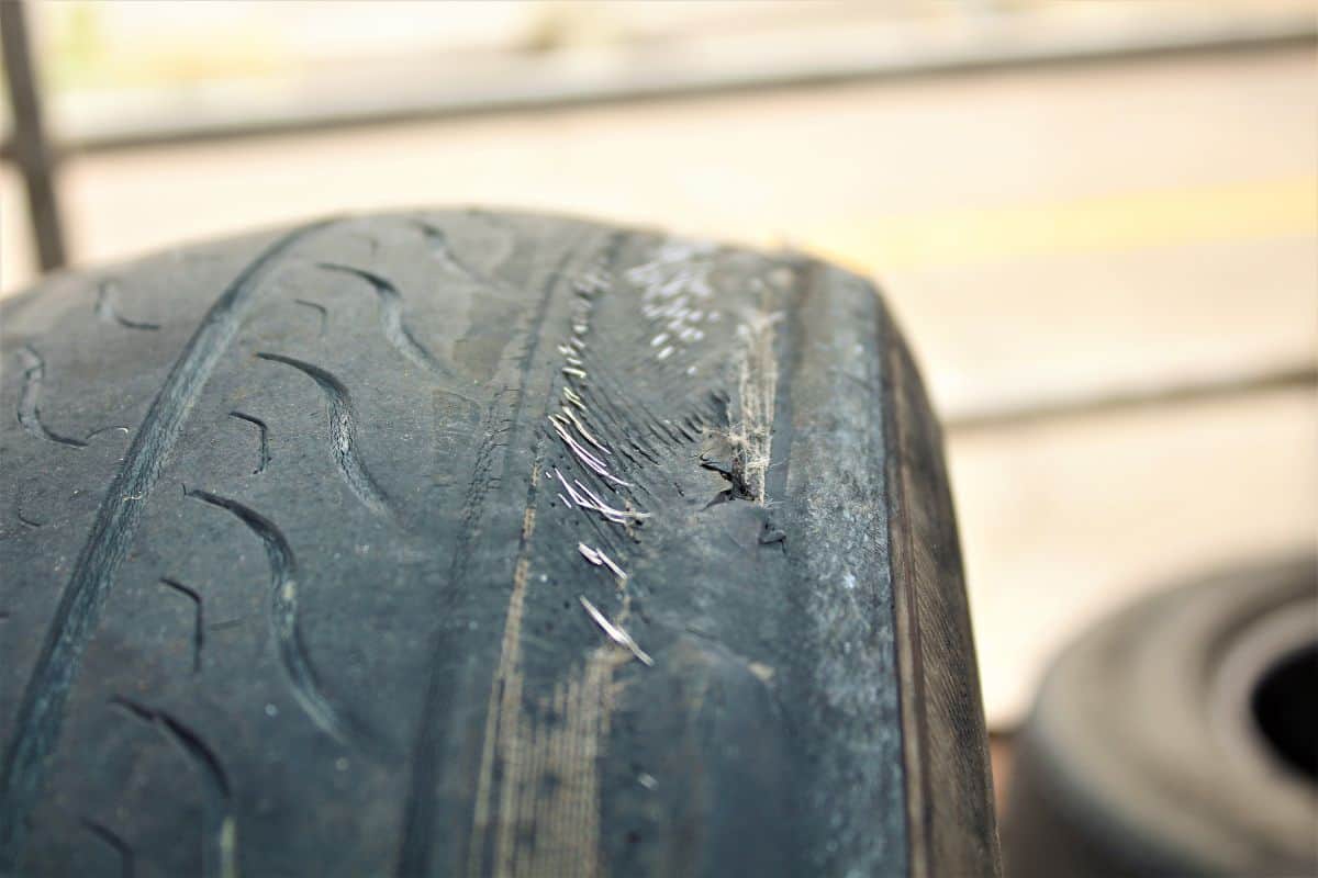 Automotive tires damage, burst, leakage. Changing tires in the garage.