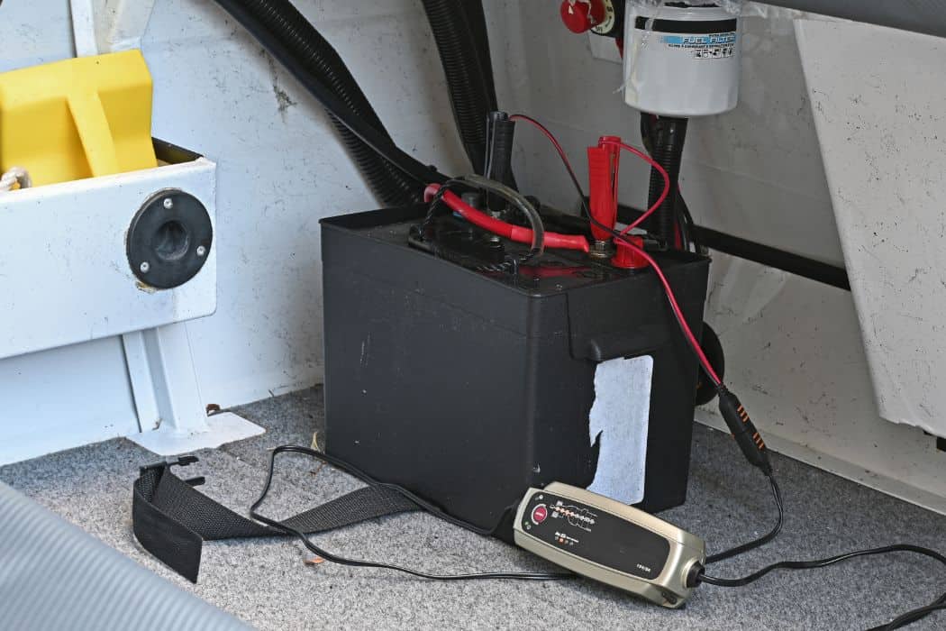 Battery in a boat being charged with a small battery charger