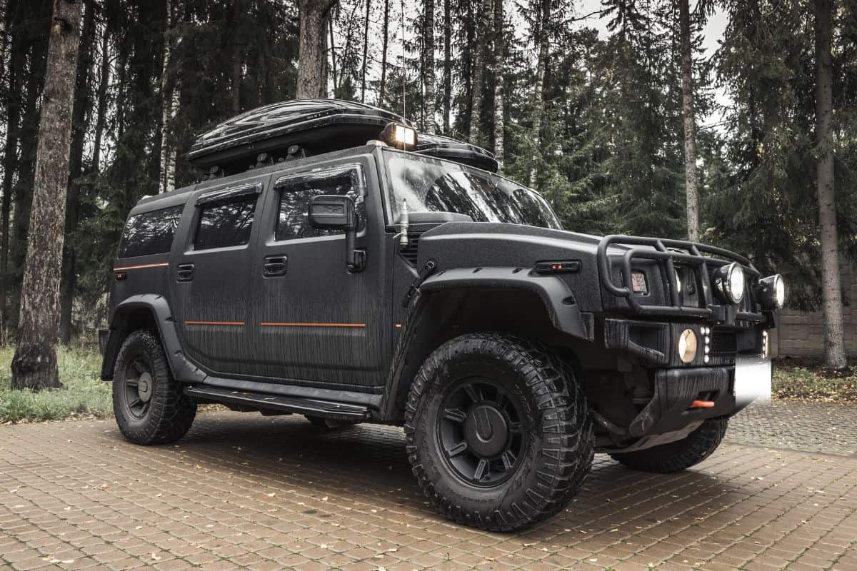 Black Hummer H2 car stands on rural parking lot in Russia