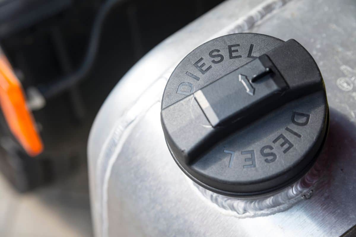 Black plastic cap of aluminum gas tank in silver color with the inscription "DIESEL". The fuel tank of the truck is closed with a cap. 
