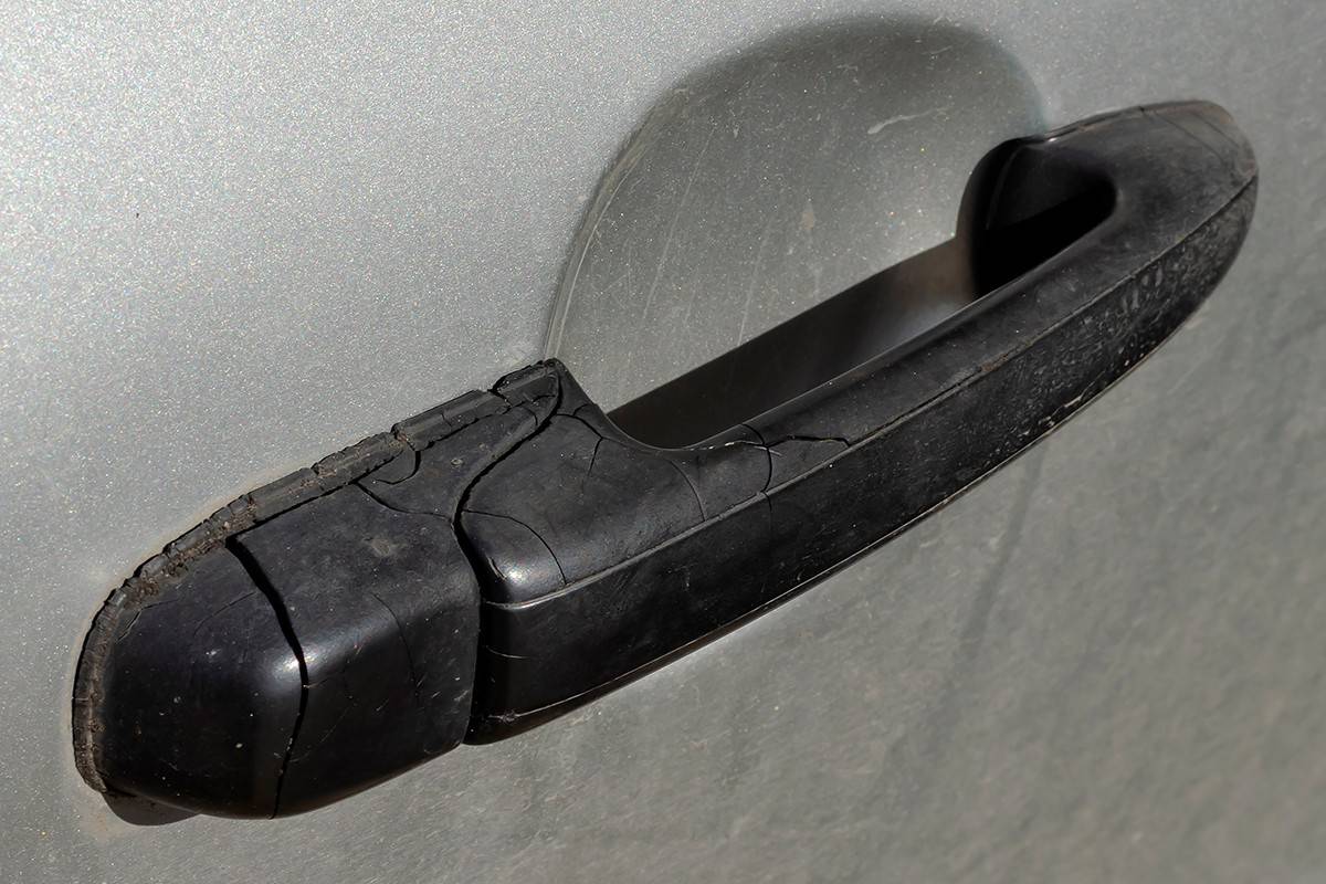 Black plastic handle on the tailgate of a sedan