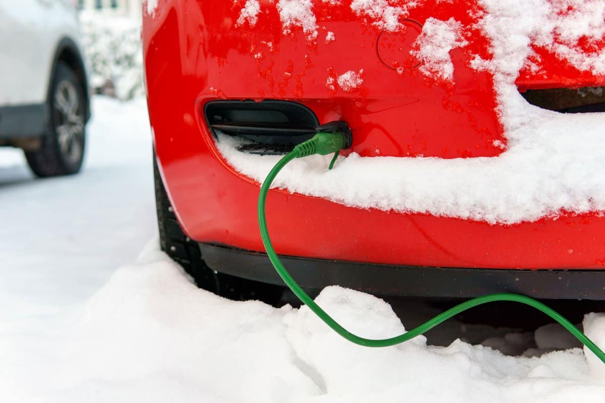 Block heater cable plugged into a car on a cold winter day to warm engine