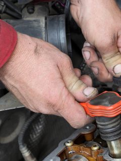 Car mechanic replacing ignition coil on gasoline engine, How Long Does It Take To Replace An Ignition Coil?