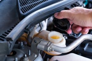 Check brake fluid,Hand open a tank for car maintenance., Hydraulic Fluid Vs. Transmission Fluid: What Are The Differences?