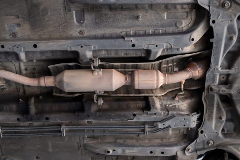 Close-up of Old Catalytic Converter and Resonator in Car Exhaust System., How Many Catalytic Converters Are In A Chevy Express Van?