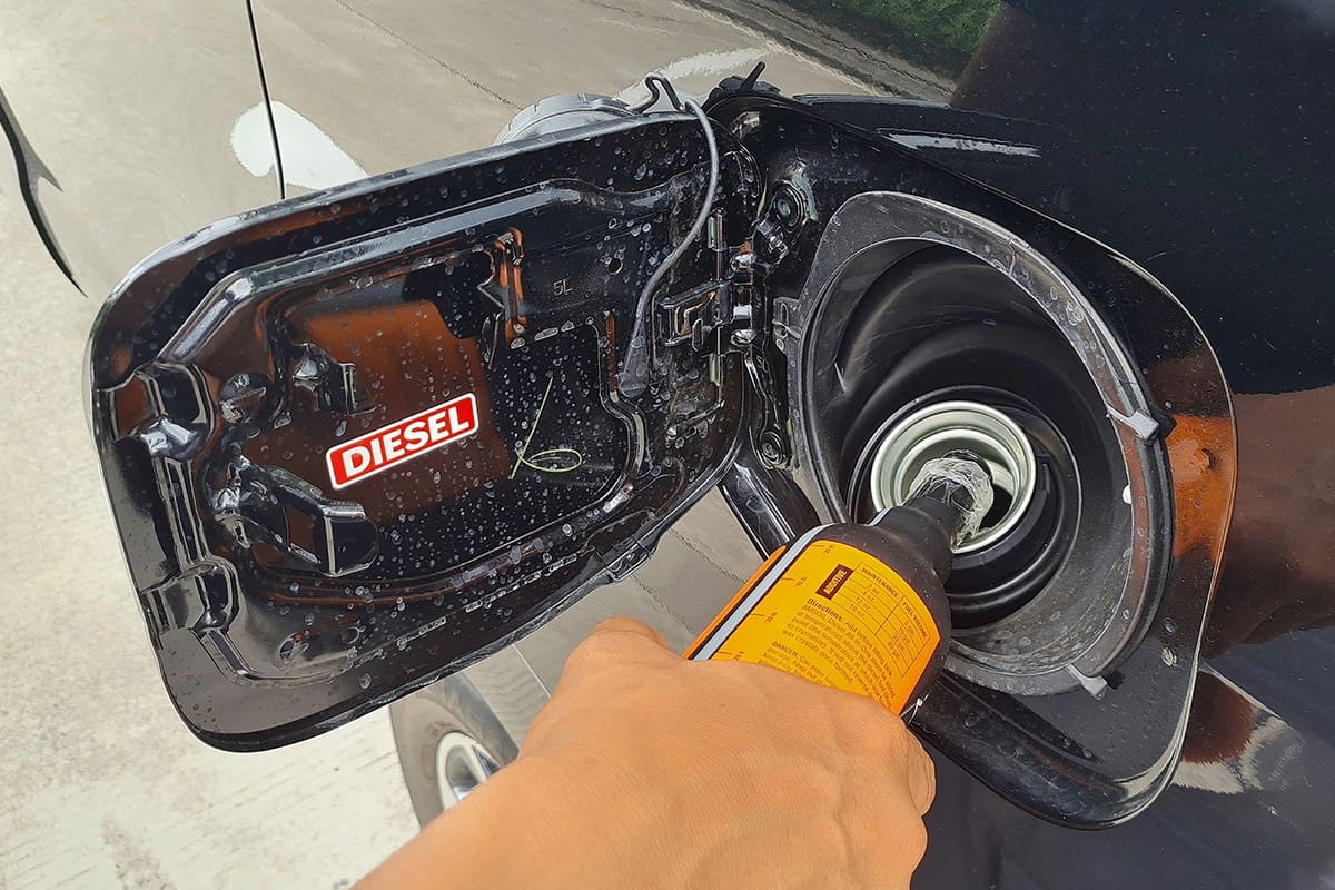Driver fills a diesel additive into a car's diesel fuel tank