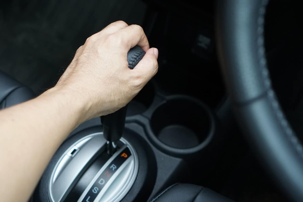 Driver hand shifting car gear stick on parking mode, Mechanism of switching modes of automatic transmission car