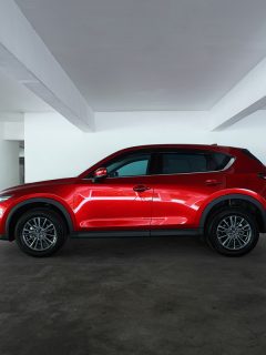 Mazda CX 5 side profile view. Modern crossover SUV parking in basement empty car park ., Battery Charger Says Fully Charged But Car Won't Start - Why? What To Do?