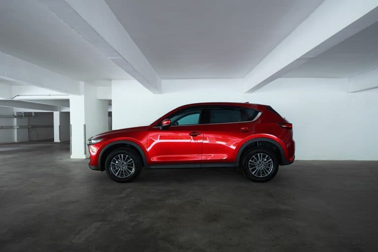 Mazda CX 5 side profile view. Modern crossover SUV parking in basement empty car park ., Battery Charger Says Fully Charged But Car Won't Start - Why? What To Do?