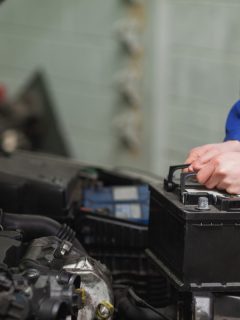 Male mechanic changing car battery, How Do You Use Schumacher Battery Maintainer? [Step By Step Guide]