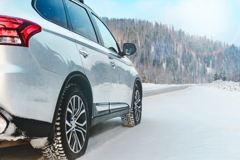Modern Suv car stay on roadside of winter road. Family trip to ski resort concept. Winter or spring holidays adventure. car on winter snowy road in mountains, What Are The Different Type Of Mud Flaps?