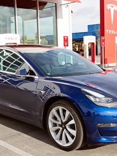 Navy blue tesla model 3 charging at supercharger station, Tesla Model 3 Creaking Noise - What Could Be Wrong?