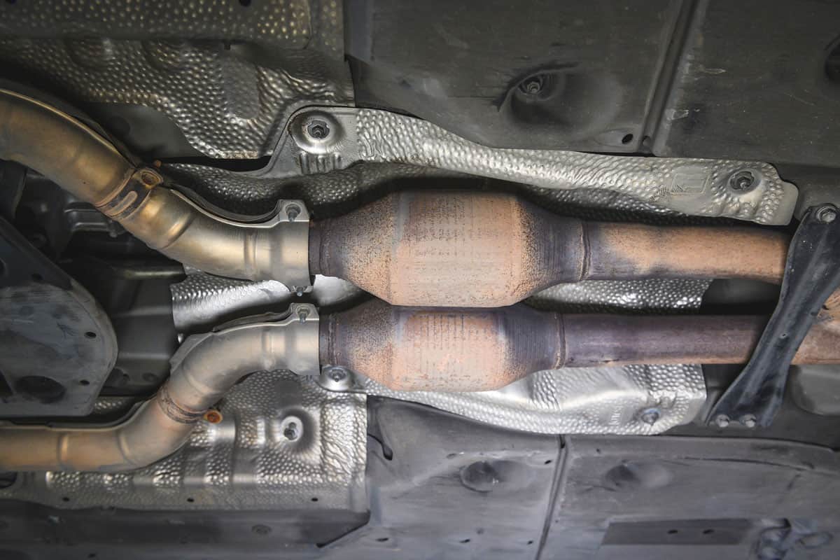 Old Used Catalytic Converter in Car Exhaust System.