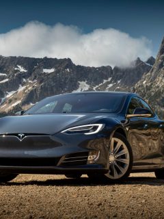 Photograph of a Tesla model 3 in front of a mountain in the wilderness, Tesla Model 3 Bearing Noise From Wheels - Why