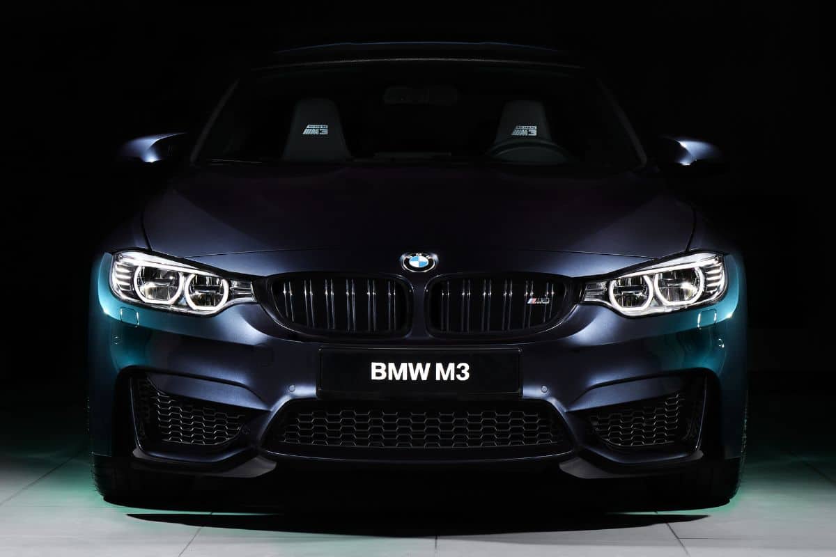 The front of the BMW M3 30 Jahre Edition standing in a dark garage.