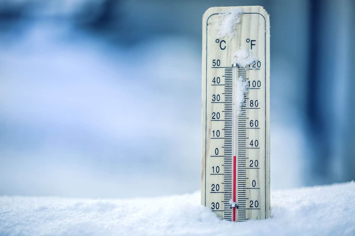 Thermometer on snow shows low temperatures in celsius or Fahrenheit