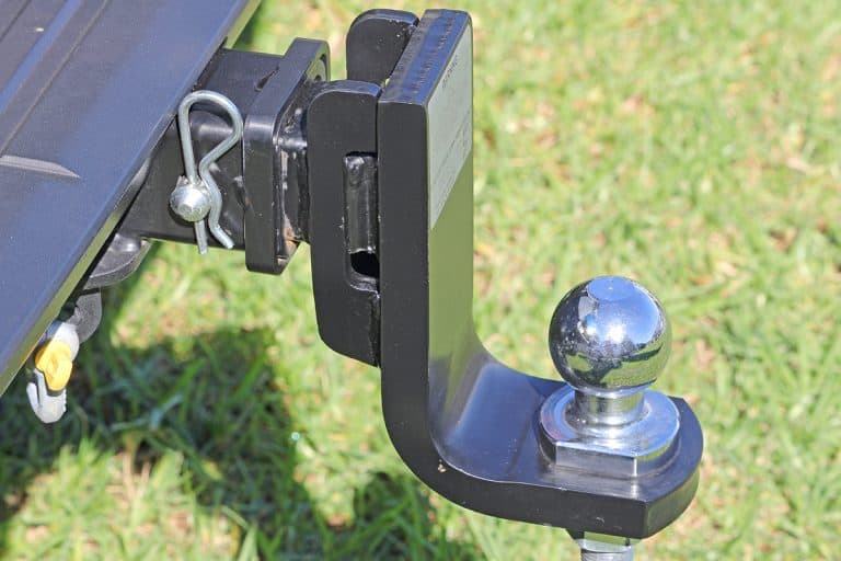 Tow bar of a car with drop down ball, What Are The Best Adjustable Drop Hitches For A Lifted Truck & What Size Do You Need?