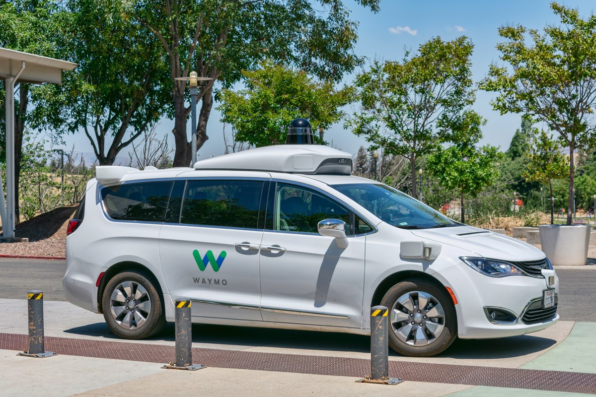 Waymo self-driving car performing tests in a parking lot near Google's headquarters.