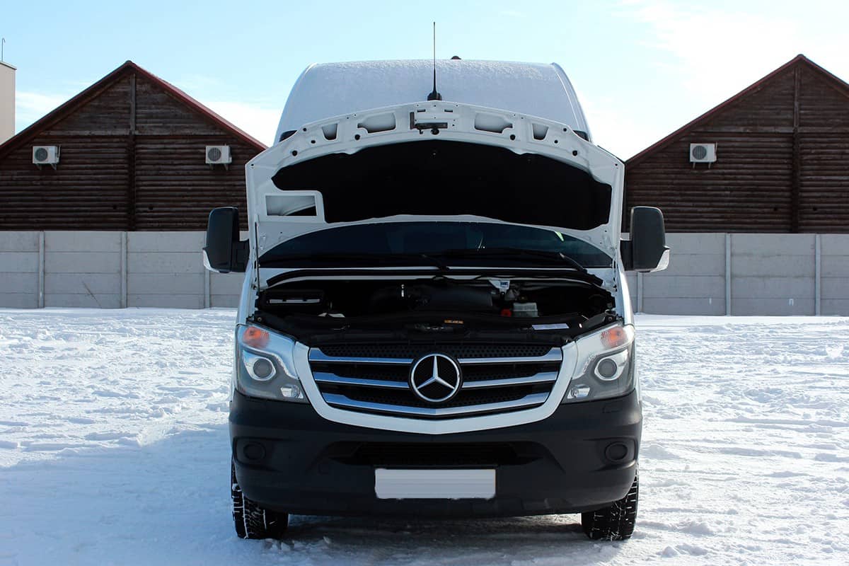 White Mercedes Sprinter 319 MAXI Cargo Van on a snow surface