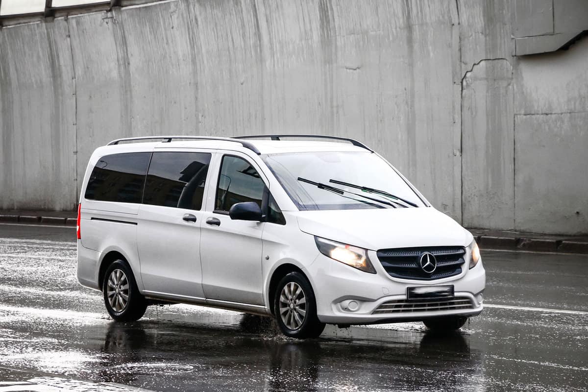 White van Mercedes-Benz W447 Viano in the city street during a heavy rain.