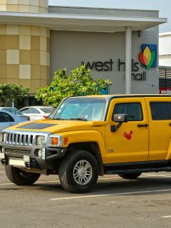 Yellow car on parking of West Hills Mall. African shopping center and cars. Modern urban landscape in developing countries, How To Put Hummer In Neutral [Inc. H2 & H3]