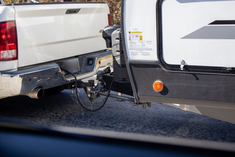 white truck towing camper rv close up, Can You Back Up With Eaz Lift Recurve R3? [Here's What You Need To Know!]