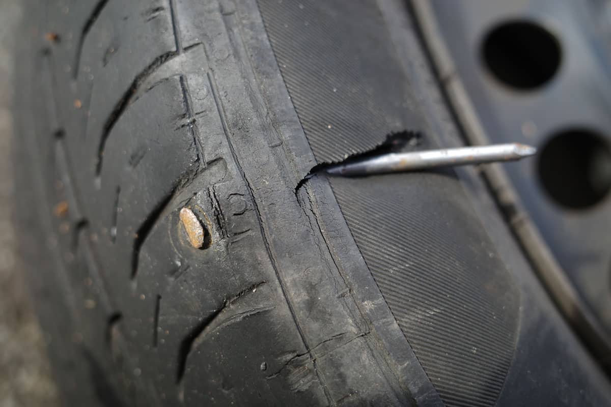 Flat tire. Tire punctured by big nail 