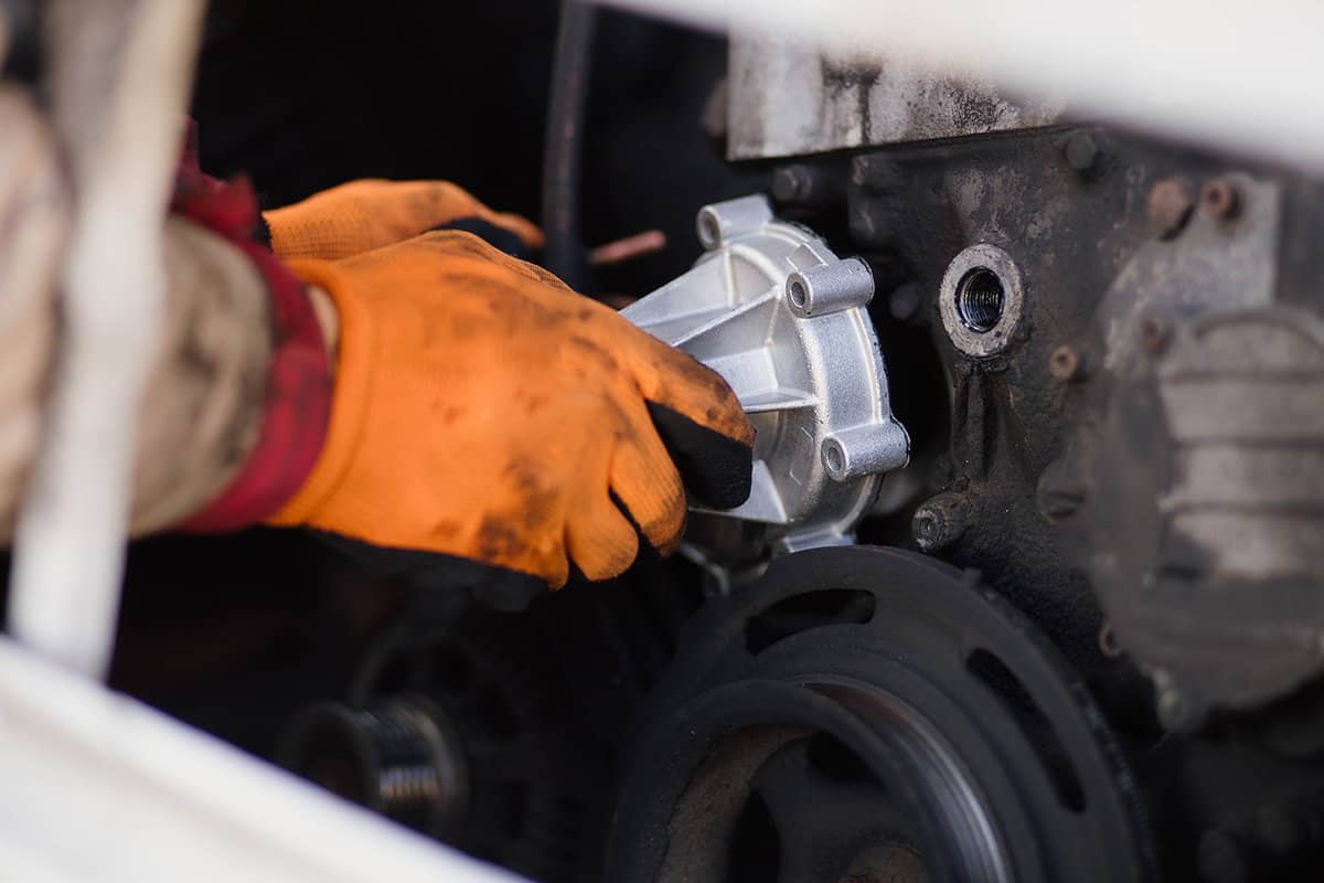 Installation of a new water pump of the engine cooling system in a car service