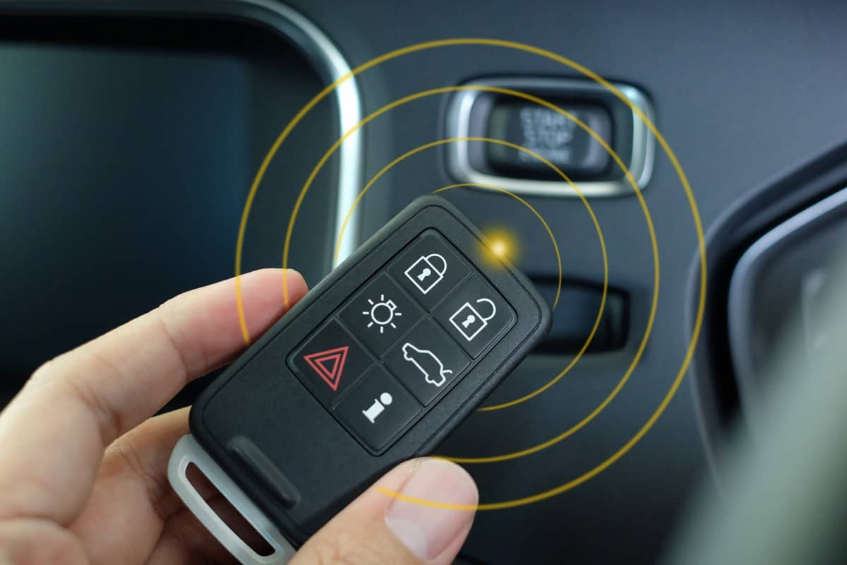Keyless entry system for car, Smart key in hand with frequency effect.