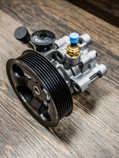 Power steering pump on wooden background. - How Long Does It Take To Replace A Power Steering Pump?