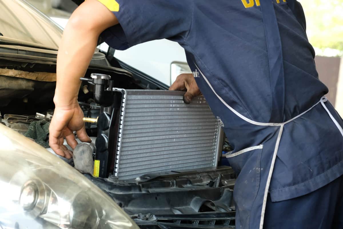 Car radiator,The car technicians is changing the new radiator in the car