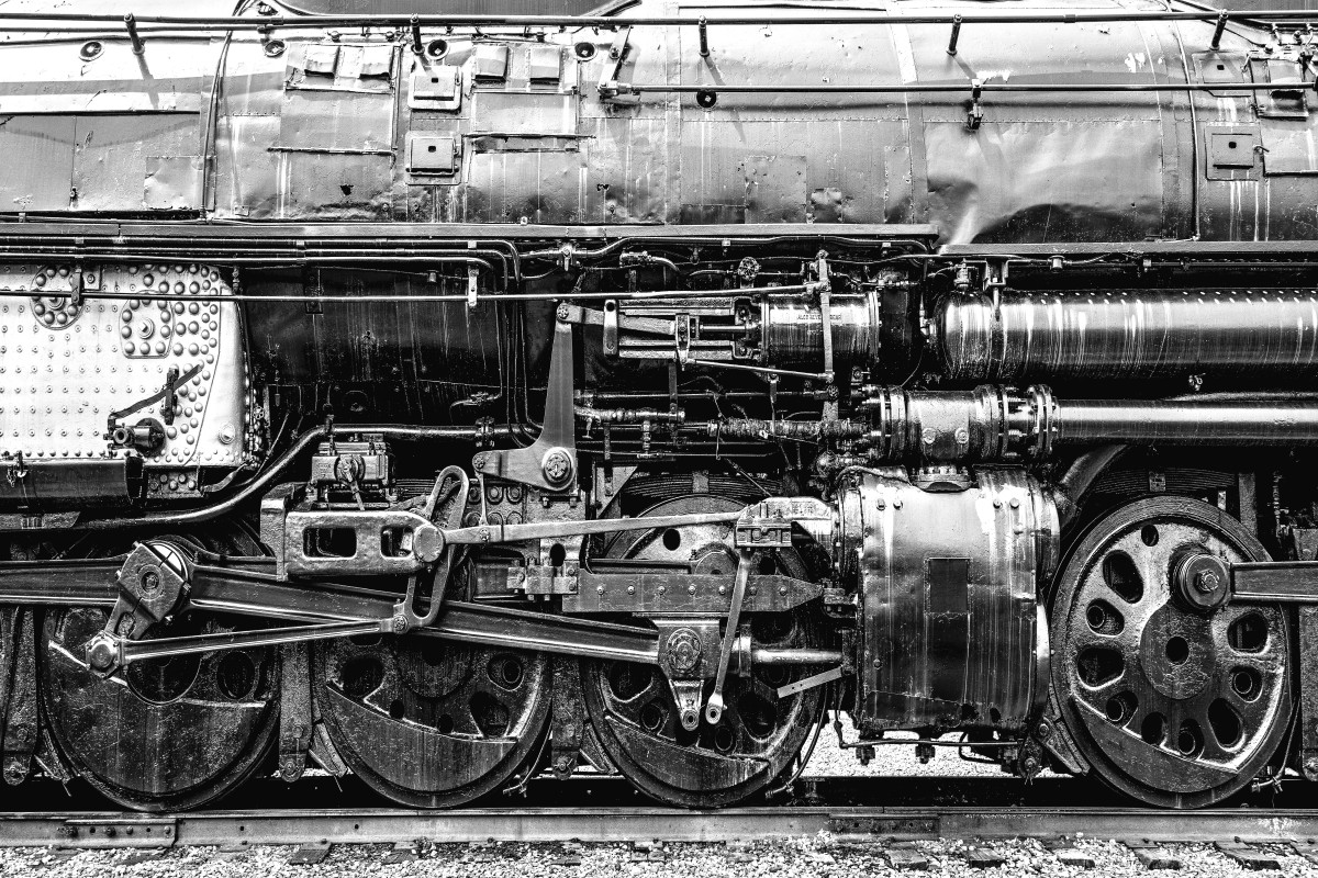 A grayscale closeup of the Union Pacific Big Boy locomotive wheels and mechanical parts 
