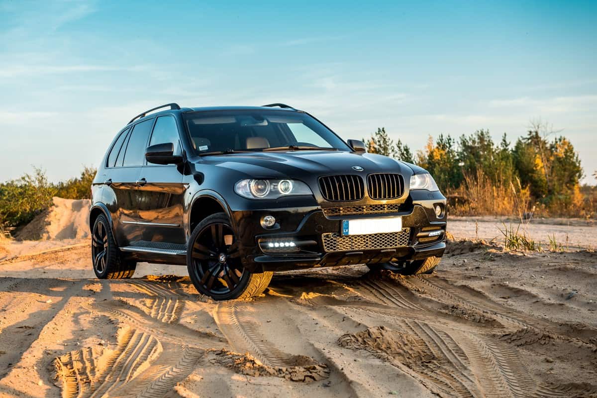 BMW X5 parked on a sandy terrain