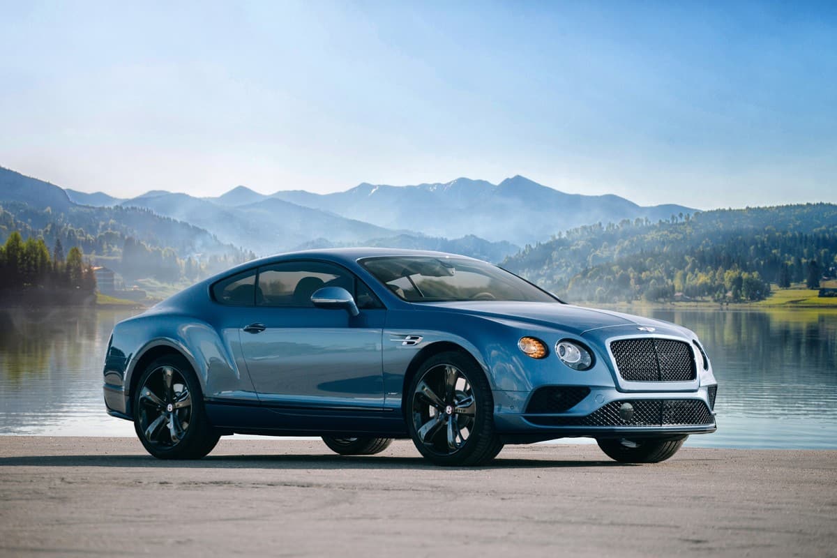 Bentley Continental GT supercar near lake and mountain background