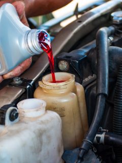 Mechanic filling red hydraulic oil in service shop, Do I Have To Use Kubota Hydraulic Fluid?
