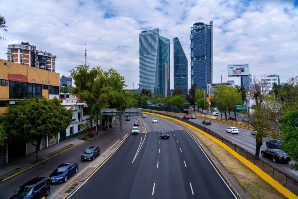 Mexico City Mexico - February 13 2022 Cars Driving Down the Freeway with Skyscrapers in the Background in Mexico City Mexico
