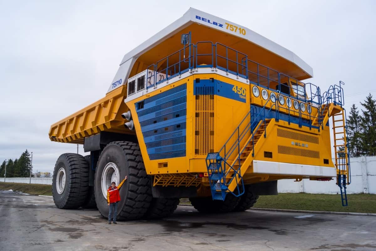 Worlds Largest Huge Truck BelAZ with man for scale. Zodzina, Belarus - March 9, 2016 Haul truck BelAZ 75710 by Belarusian manufacturer BelAZ with man for scale.
