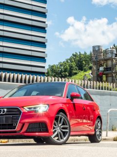 A red colored Audi A3 parked close to a building, Why Is My Audi A3 Burning Oil? Quick Troubleshooting Guide