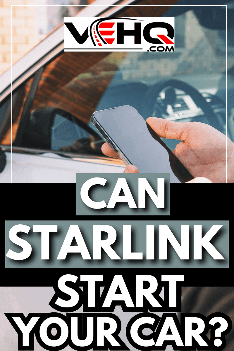 Man holding mobile phone next to door of his car in the street. - Can Starlink Start Your Car?